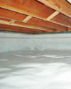 a moisture barrier installed on the walls and floors of a crawl space in Manhasset