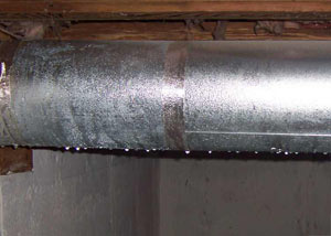 condensation collecting on an HVAC vent in a humid Dix Hills basement