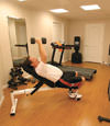 a basement gym and workout room with a wood laminate flooring, installed in Deer Park, LI
