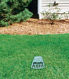 A buried gutter drain downspout extension installed in a Melville home