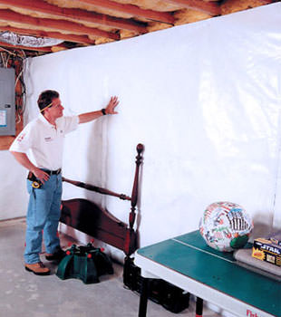 Bright white plastic vapor barrier on a concrete wall