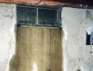 Water pouring out from a basement window in Great Neck