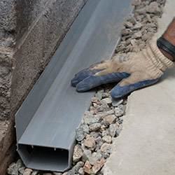 installing a drain tile system in a South Merrick home